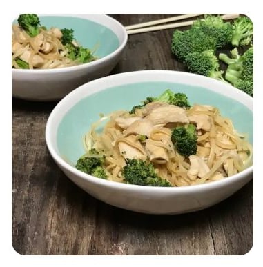 A bowl of stir fried chicken, broccoli and noodles
