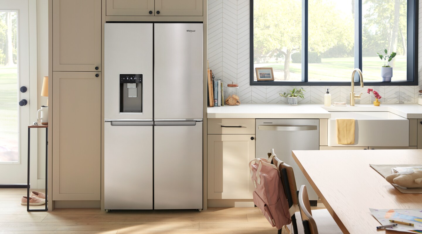 A French door refrigerator in a kitchen with light cabinets A French door refrigerator in a kitchen with light cabinets