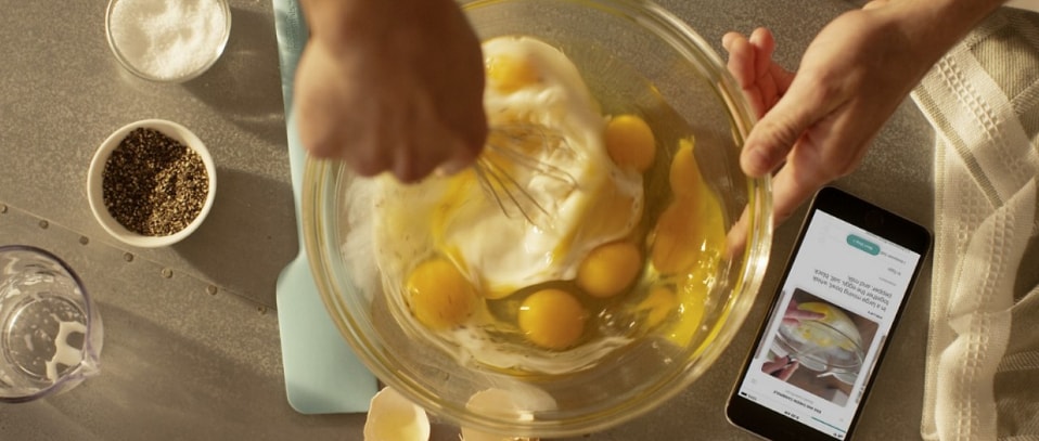 A person whisking eggs in a bowl