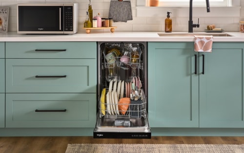 An open Whirlpool® Dishwasher in a kitchen