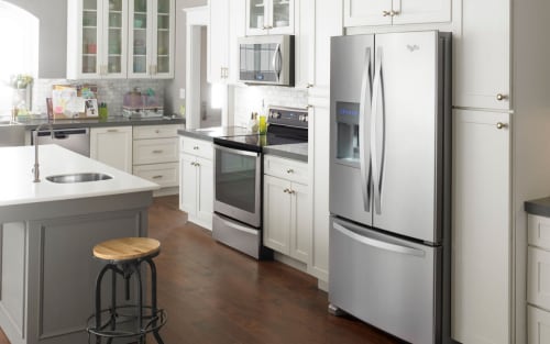 Stainless steel Whirlpool® French door refrigerator in white cabinetry