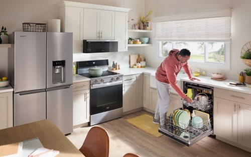 A man unloading his dishwasher