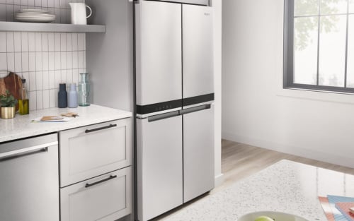 A bright, white kitchen with a 4-door refrigerator