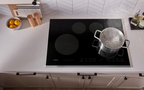 A pot of water boiling on an induction cooktop