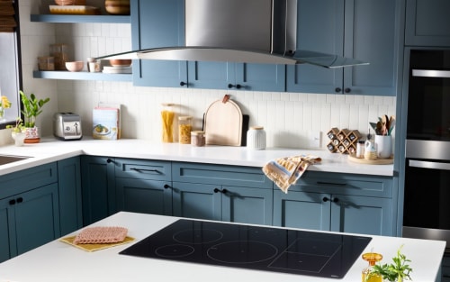 A canopy range hood over a kitchen island
