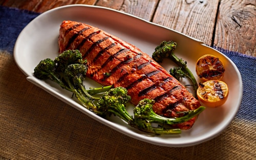 Two glazed miso-ginger salmon fillets with crispy broccolini fresh from a Whirlpool®  air fryer
