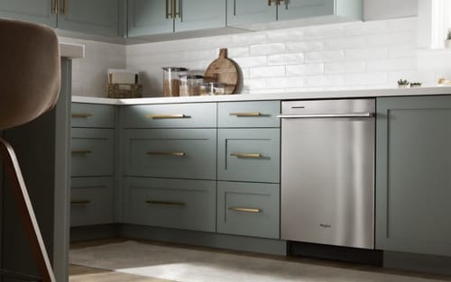 Whirlpool® Dishwasher set in light green cabinetry