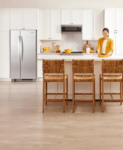 A person in a bright white kitchen.