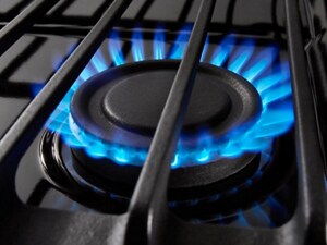 Close up of a blue gas stovetop burner flame