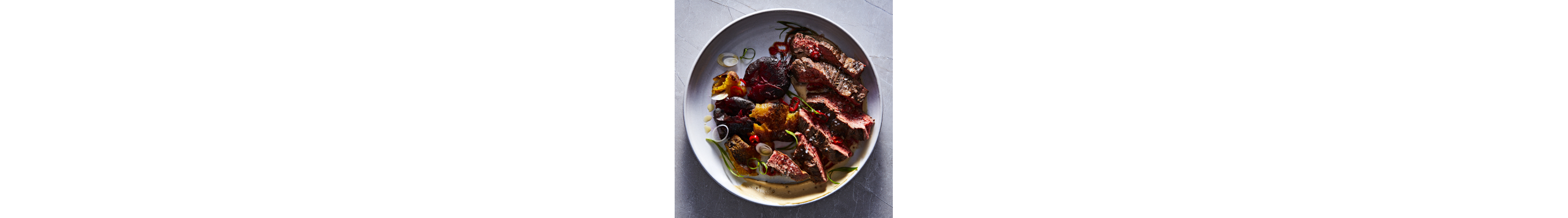Steak and vegetables in a shallow bowl