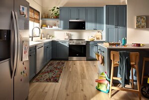 A suite of Whirlpool® stainless steel appliances in a cornflower blue kitchen