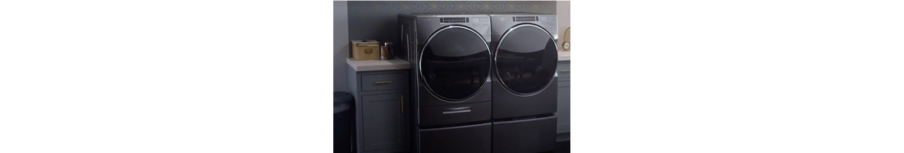 Whirlpool® Top Load Washer and Dryer in a laundry room