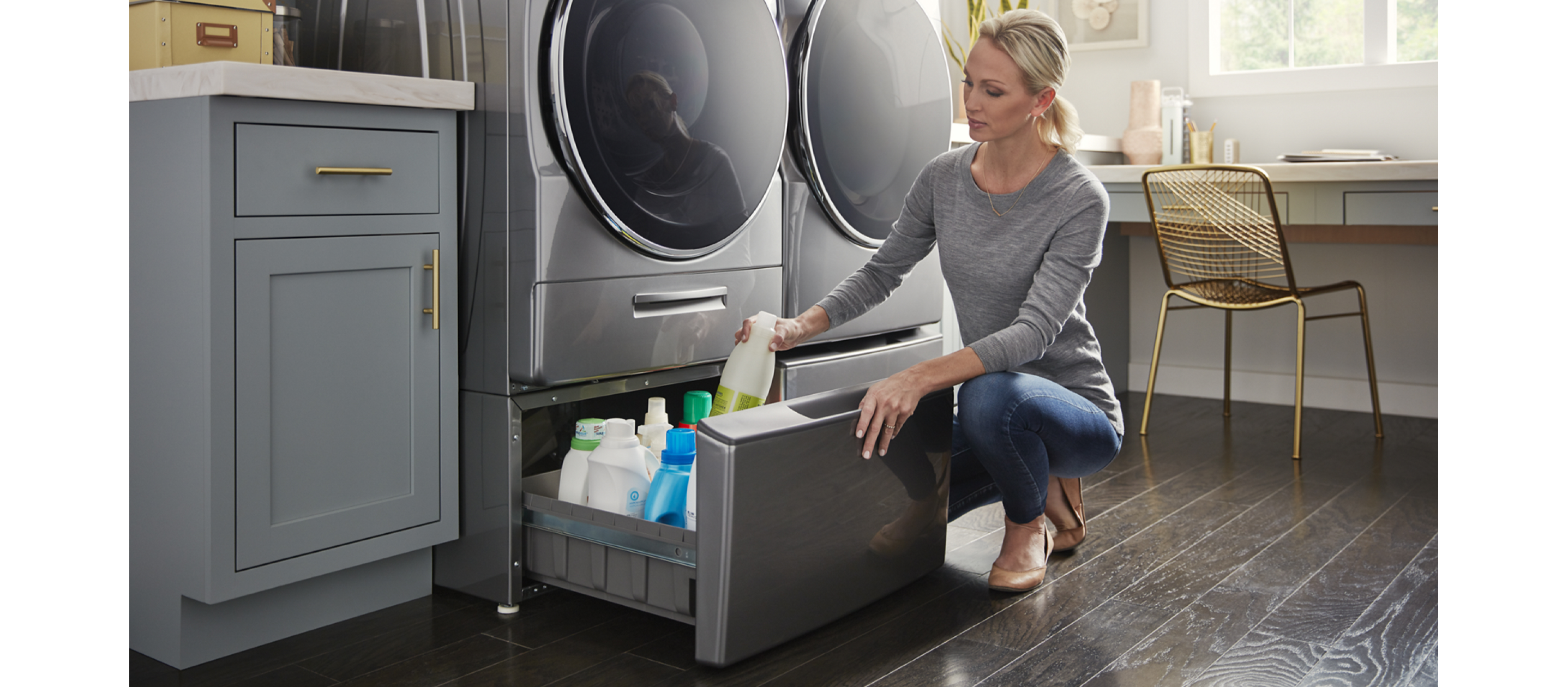 Woman taking cleaning products out of laundry pedestal