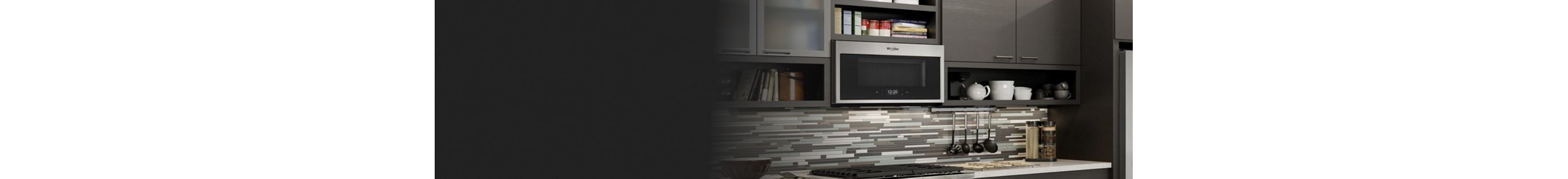 A Whirlpool® microwave installed over a gas range