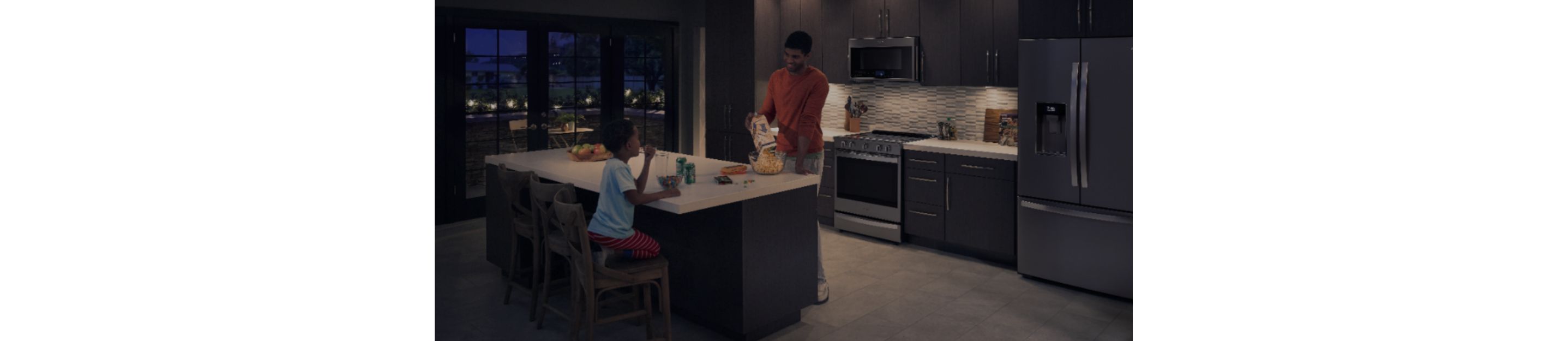 Father and daughter in the kitchen.