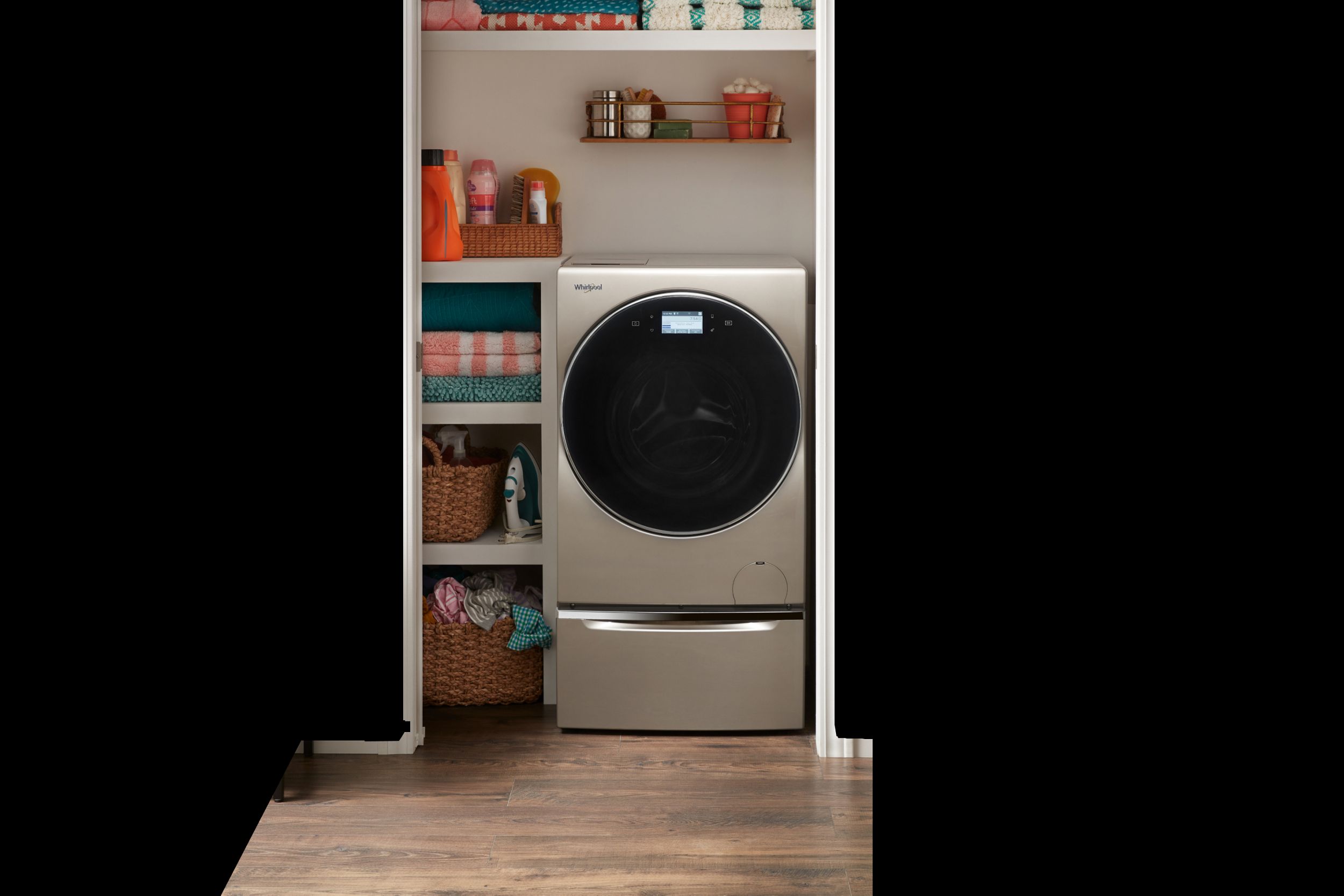 A laundry closet in a clean home with wood floors.