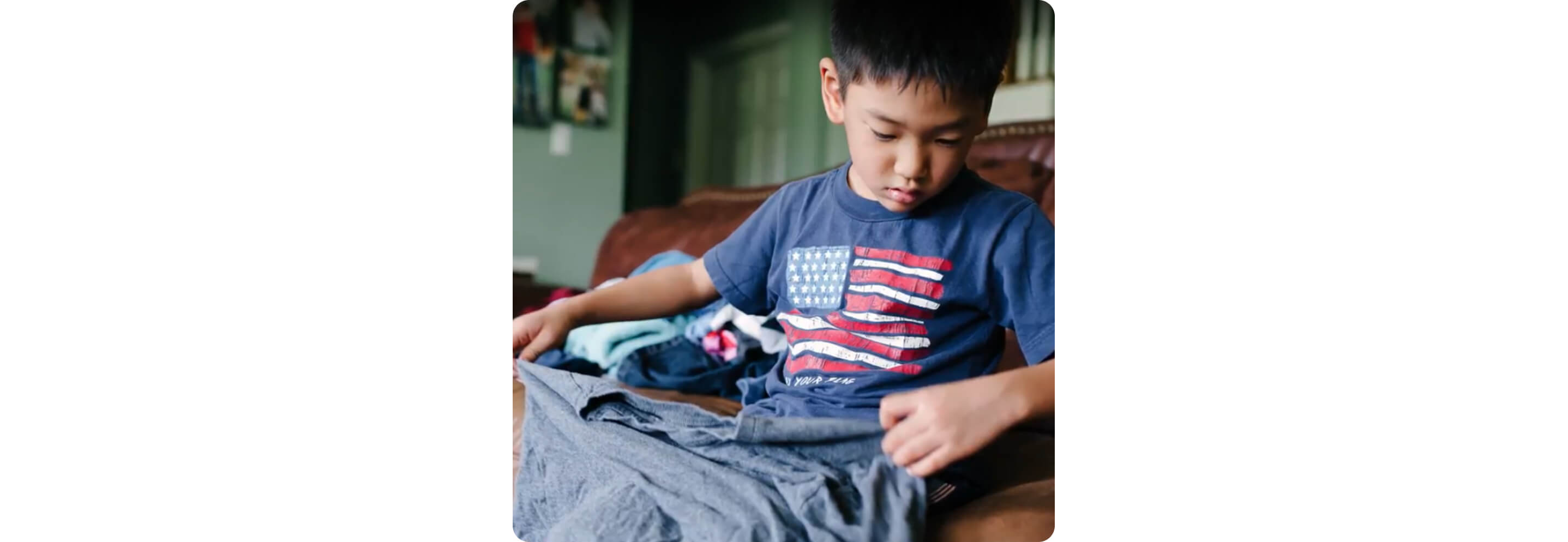 A child folding a T-shirt