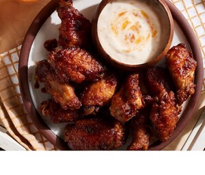 Buffalo wings and sauce on a plate