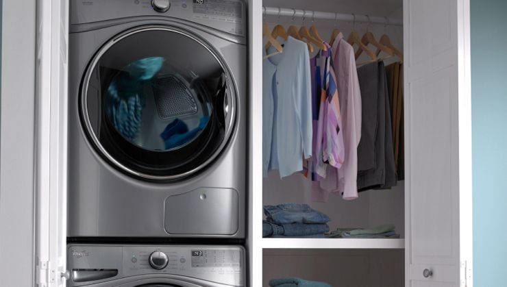 A Whirlpool stackable dryer in a laundry closet.
