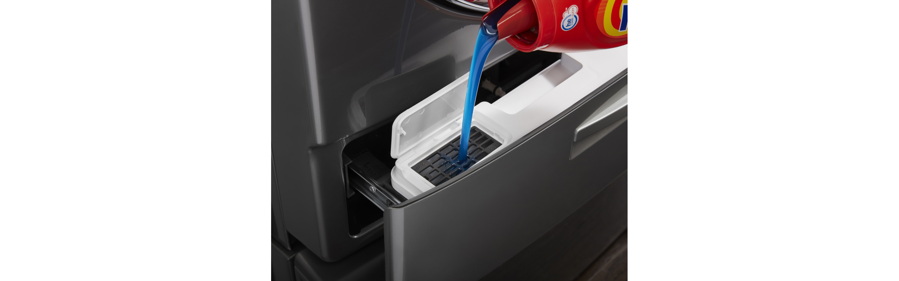Close-up of detergent being added to a front load washer and dryer set.