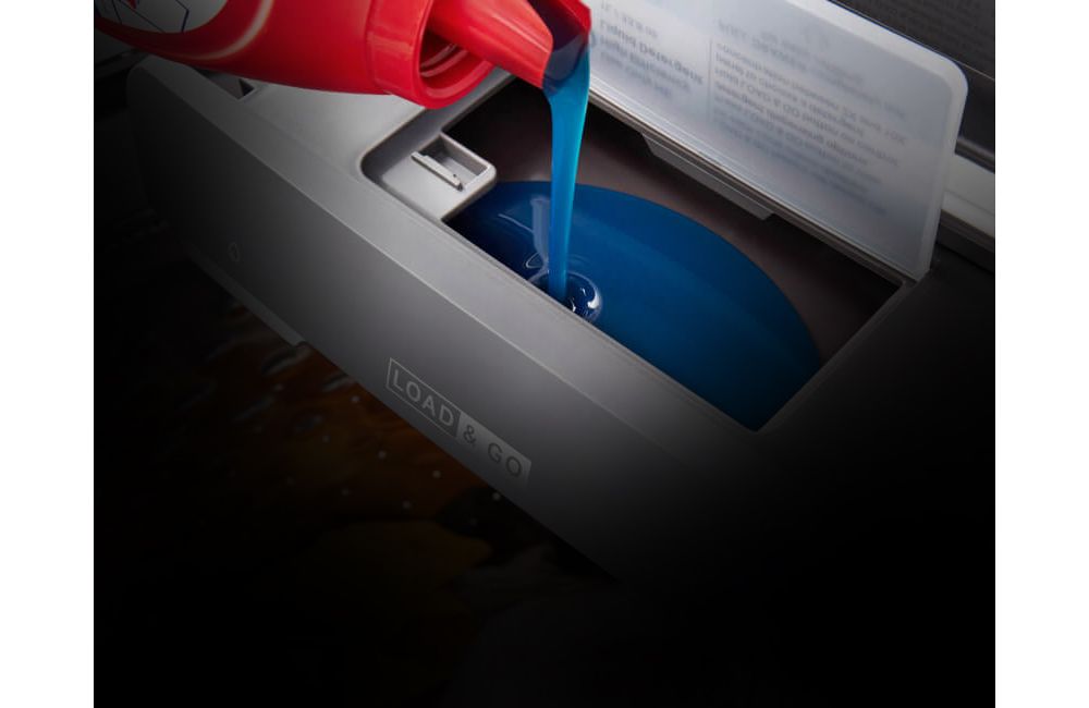 Detergent being poured into the dispenser of a Whirlpool Washing Machine