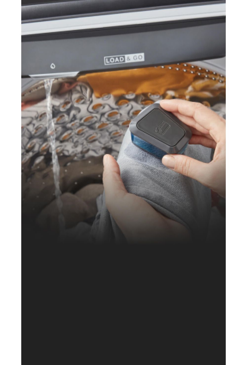 Someone scrubbing a piece of  clothing with a brush in the prewashing station of a Whirlpool Washing Machine. Water pours down from the station