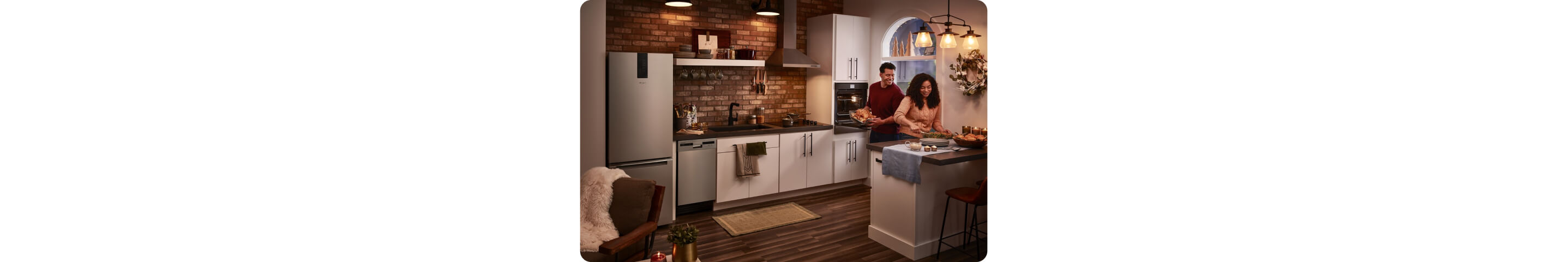 Two people preparing food in a small space kitchen