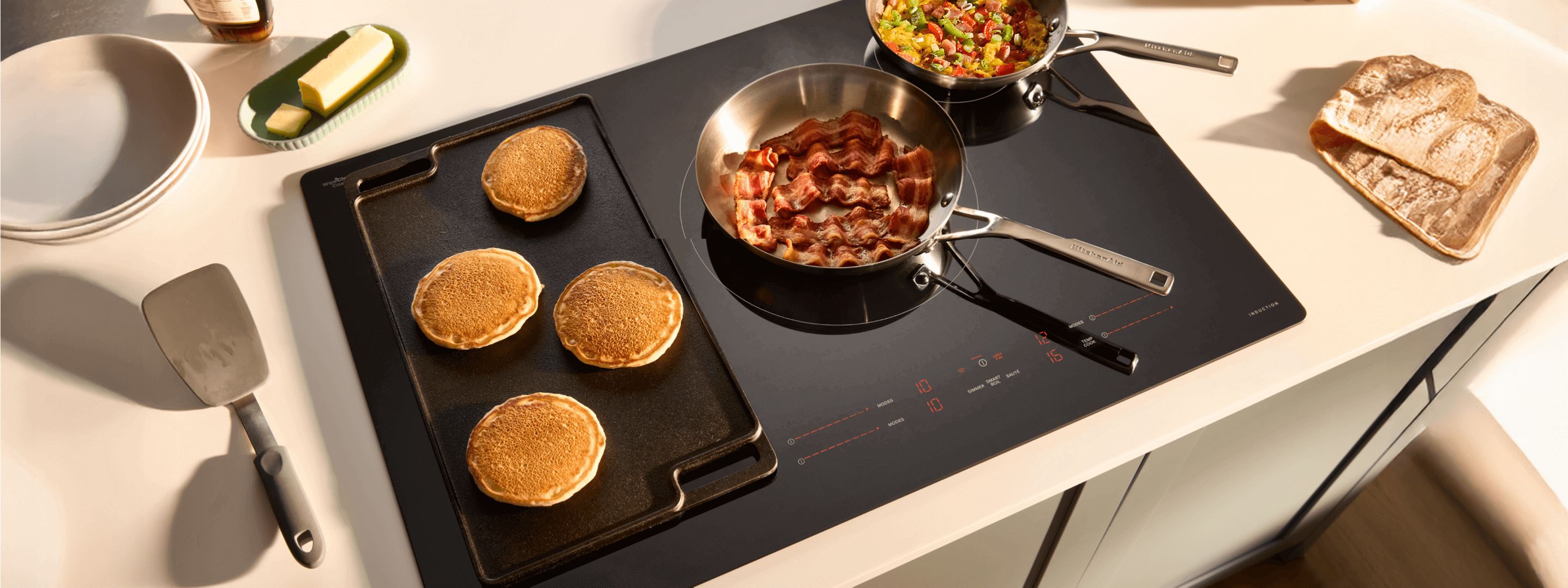 Multiple pans and a griddle on a Whirlpool® Induction Cooktop