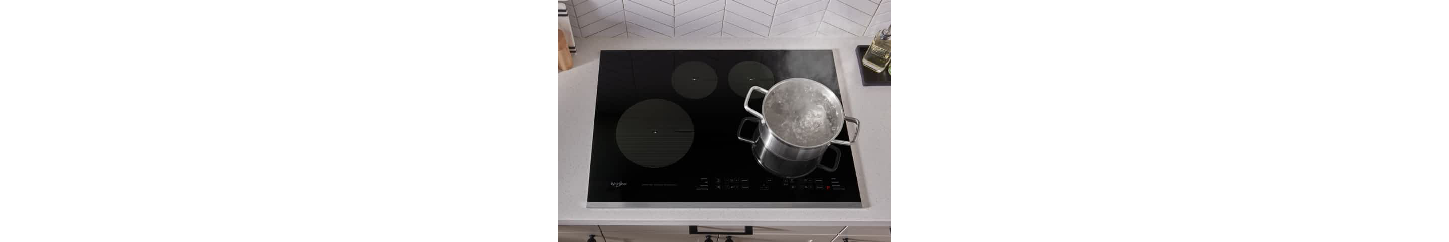 Water boiling in a large pot on Whirlpool® Electric Cooktop