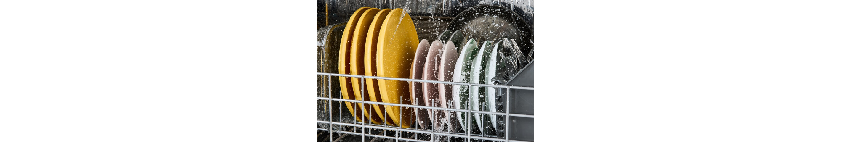 Muted colored plates being washed inside of a Whirlpool® Dishwasher