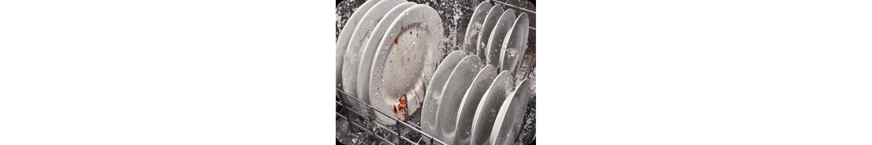 Water spraying dirty plates in a dishwasher