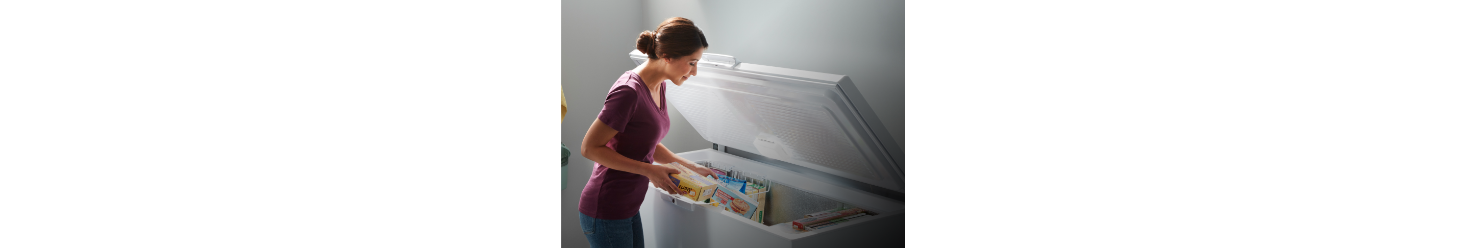 A person placing items into a Whirlpool® Deep Freezer