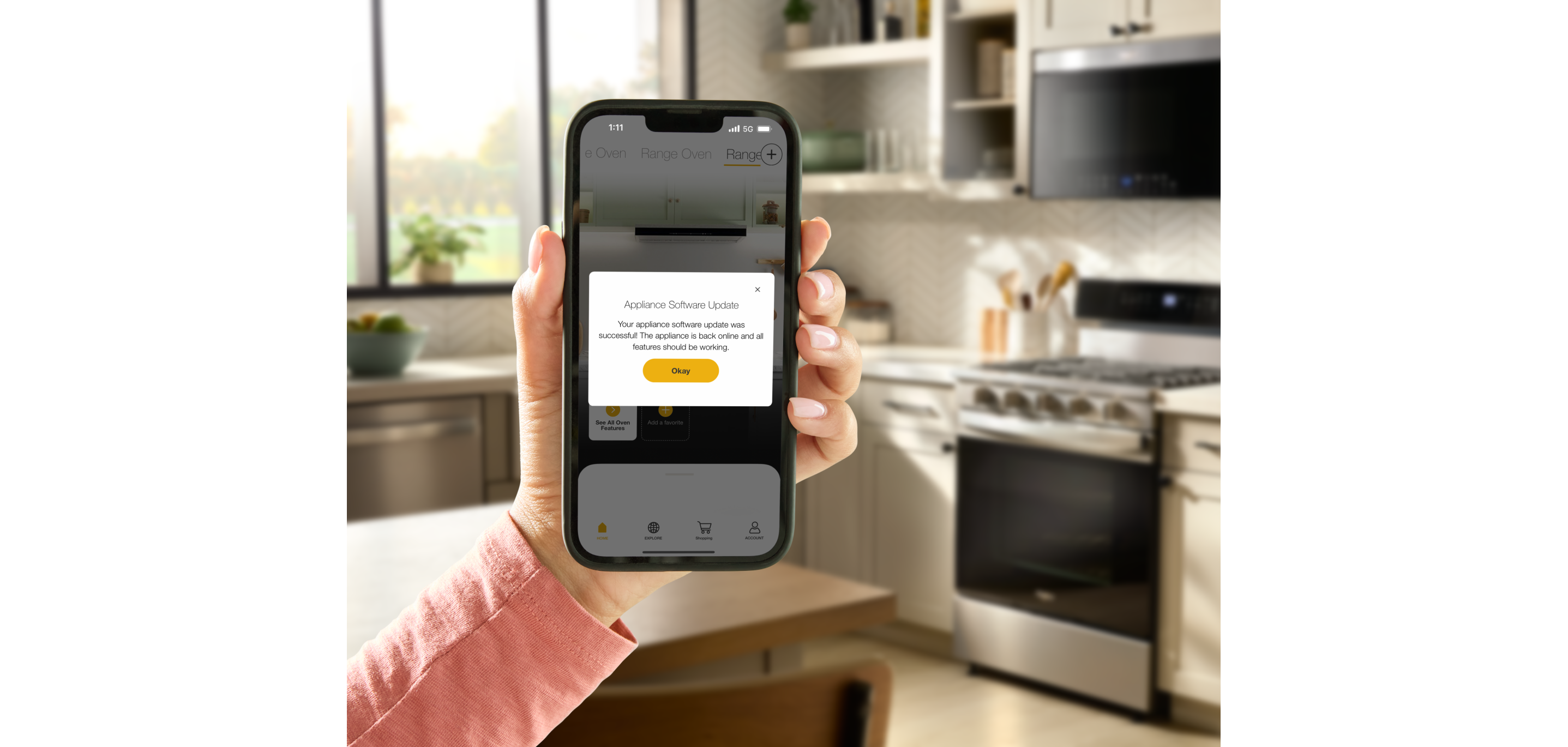 A hand holding the Whirlpool® App showing an update for the Whirlpool® Smart Range