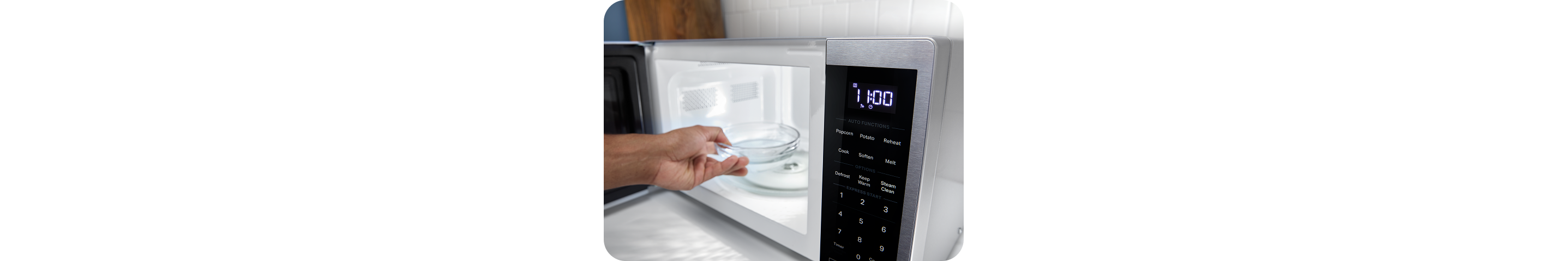 A person adding a bowl of water to a Whirlpool® Microwave