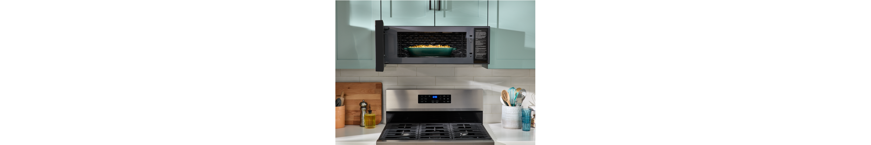 A Whirlpool® Low Profile Microwave with a dish inside.