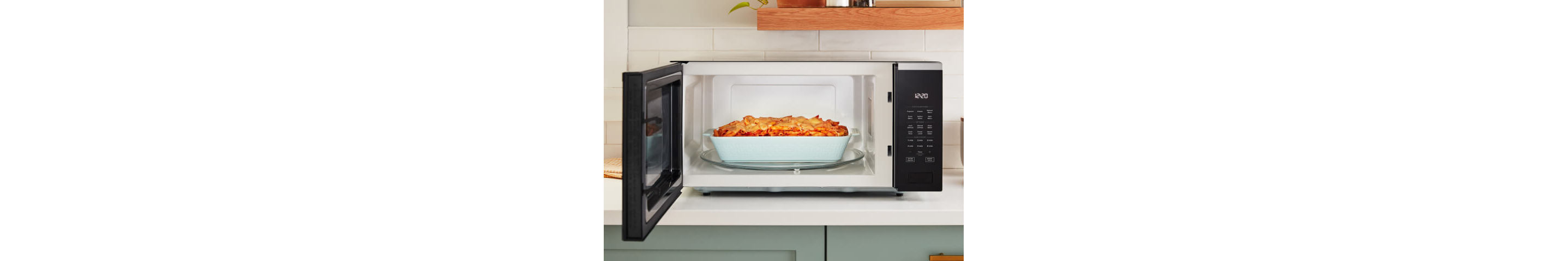 A casserole dish with baked ziti sits inside of a Whirlpool® Microwave