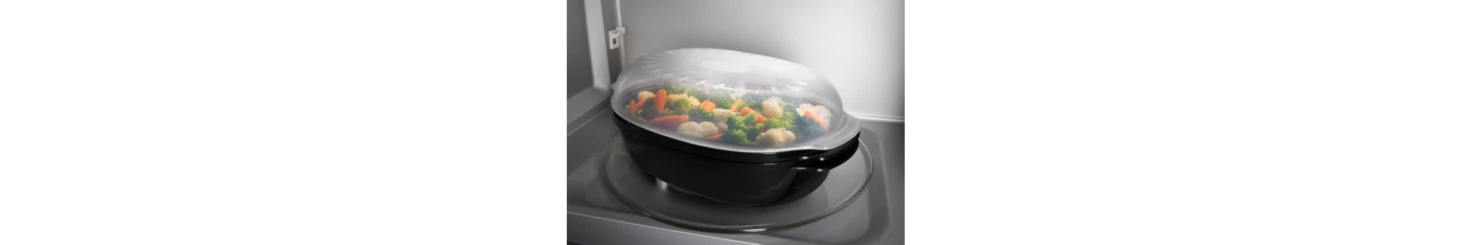 The inside of a microwave shows a bowl of food being steamed.