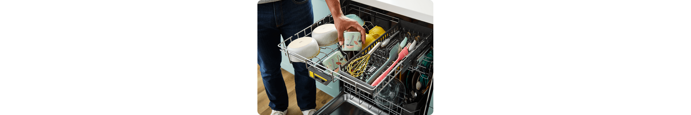 A third rack of a dishwasher loaded with clean bowls, cups and utensils