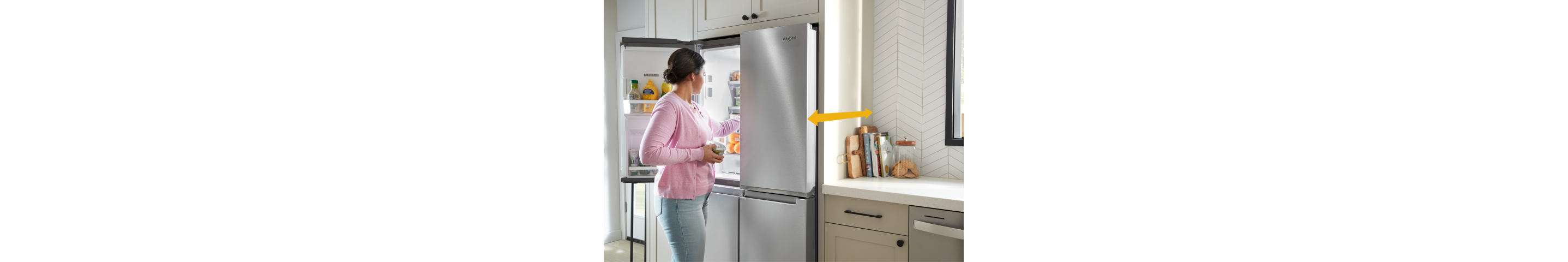 A person opening their refrigerator