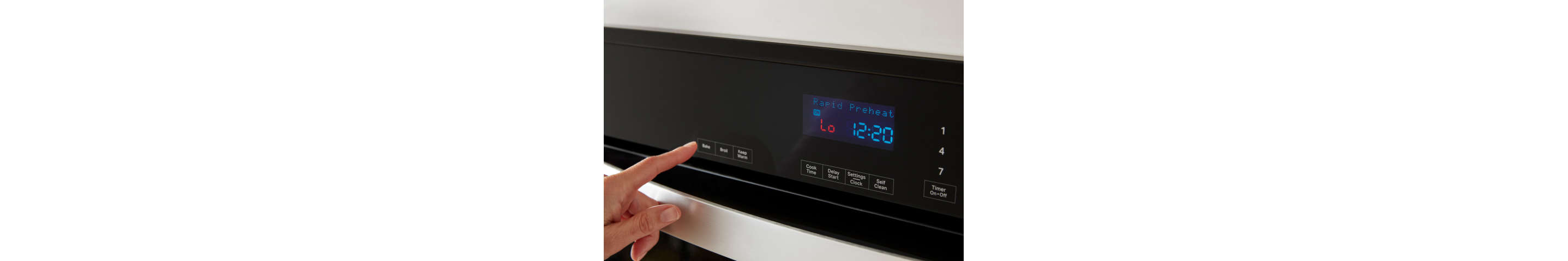 Closeup of a Whirlpool® Wall Oven console showing Rapid Preheat and a hand pressing the Bake button