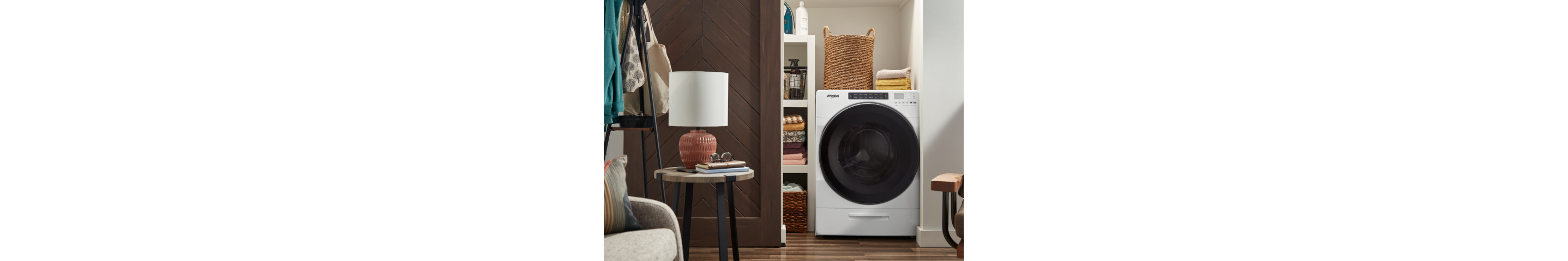 White Whirlpool® All-In-One Washer & Dryer inside of a closet with a sliding barn door