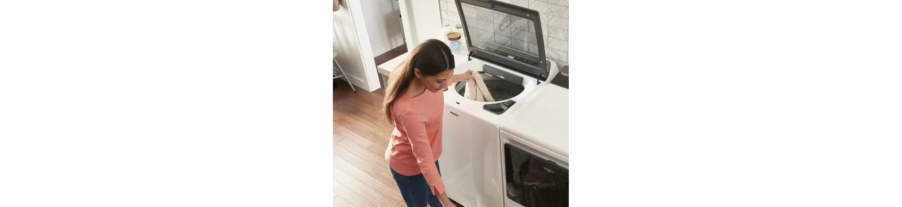 A person loading laundry into a Whirlpool® Washer