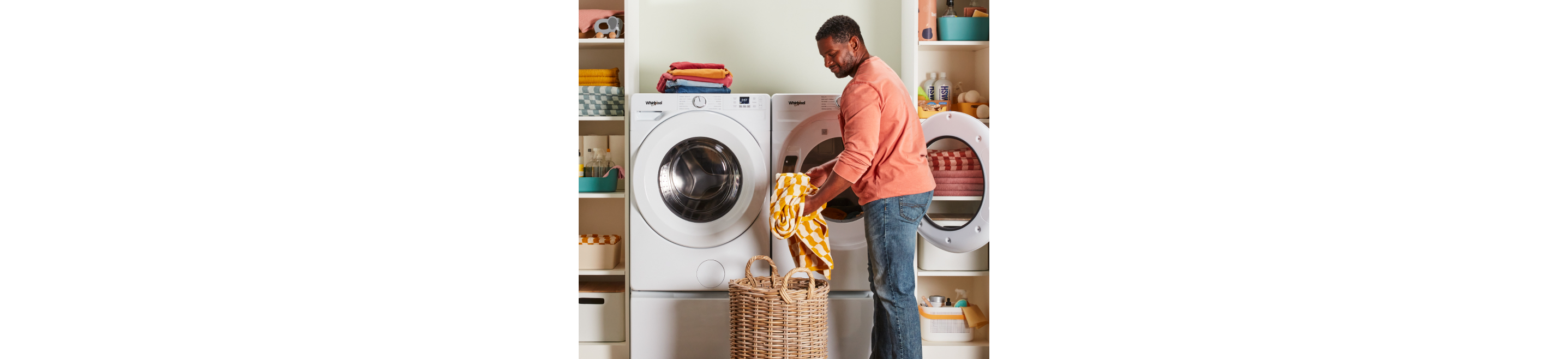 A person taking clothes out of a Whirlpool® Dryer