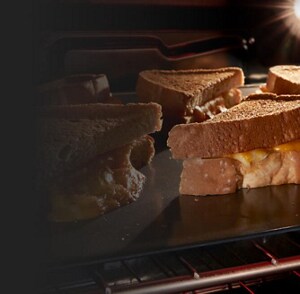 Grilled cheese on a pan under a broiler