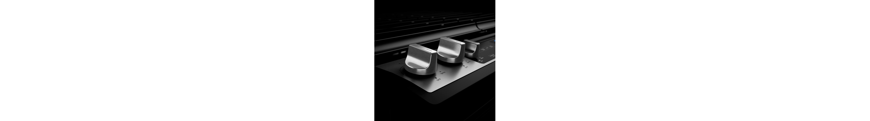 Stainless steel knobs on a gas range.
