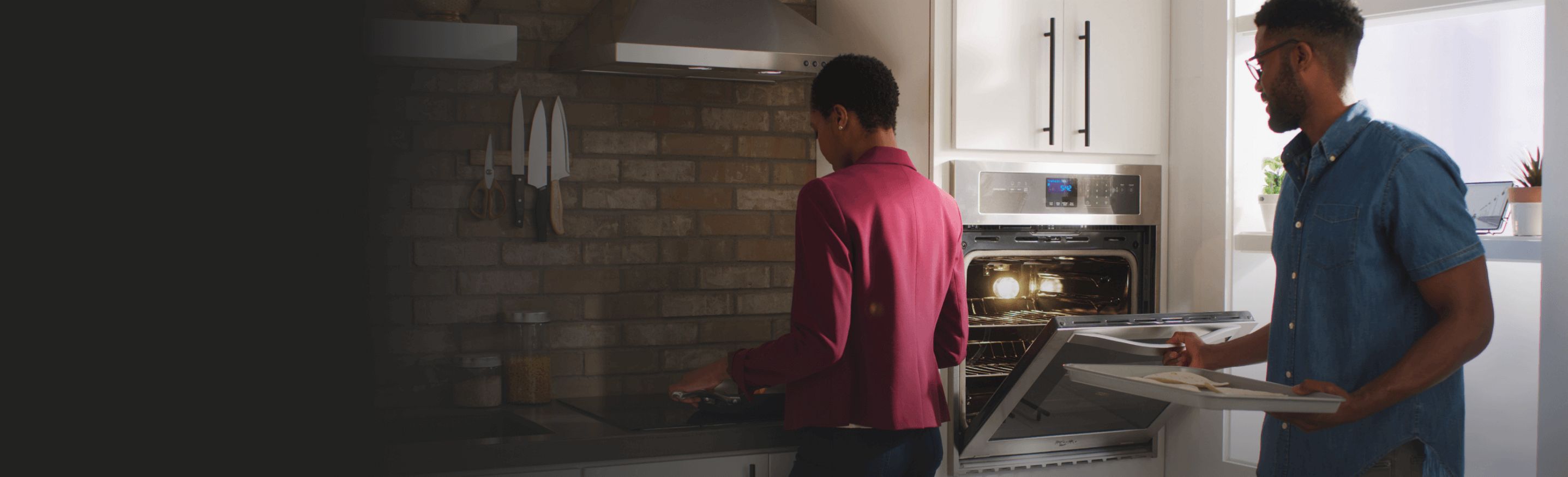 A couple cooking in a kitchen.