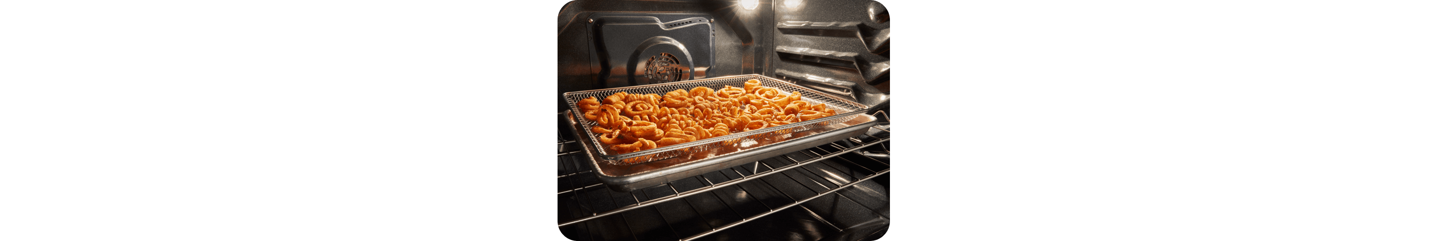 Curly fries being air fried in a Whirlpool® Range Oven