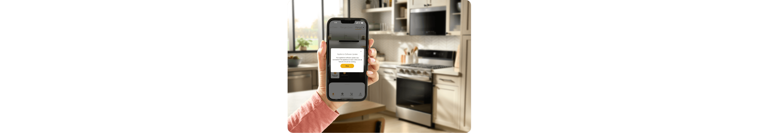 A hand holding the Whirlpool® App showing an update for the Whirlpool® Smart Range