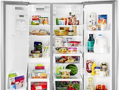 Whirlpool side-by-side refrigerator with open doors.