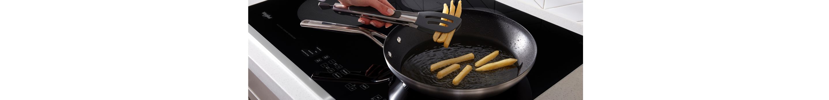 French fries being cooked on a Whirlpool® Electric Cooktop